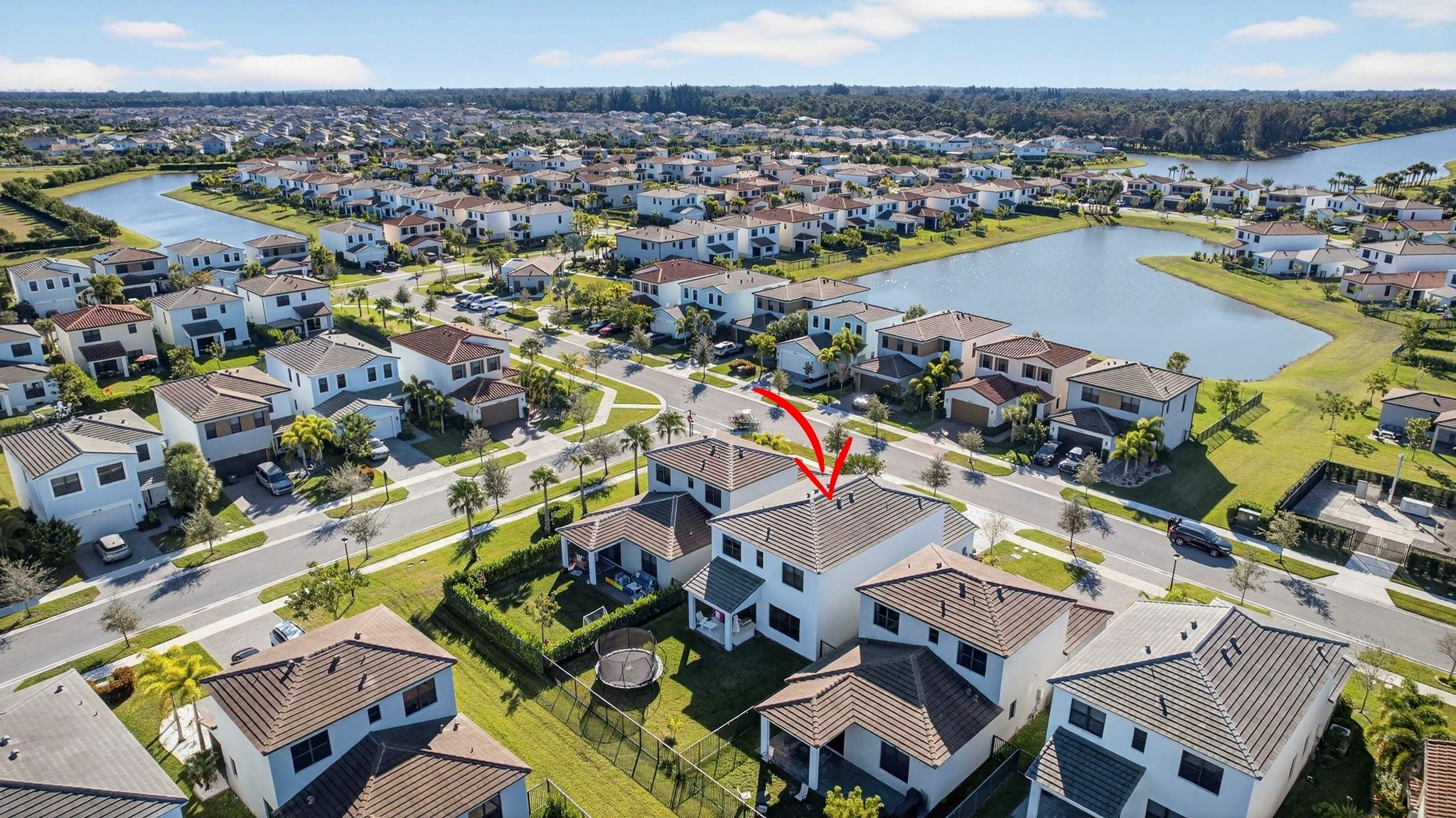 16587 Cove Road The Acreage, FL 33470 - Photo 60 of 69 an aerial view of a city with lots of residential buildings and ocean view