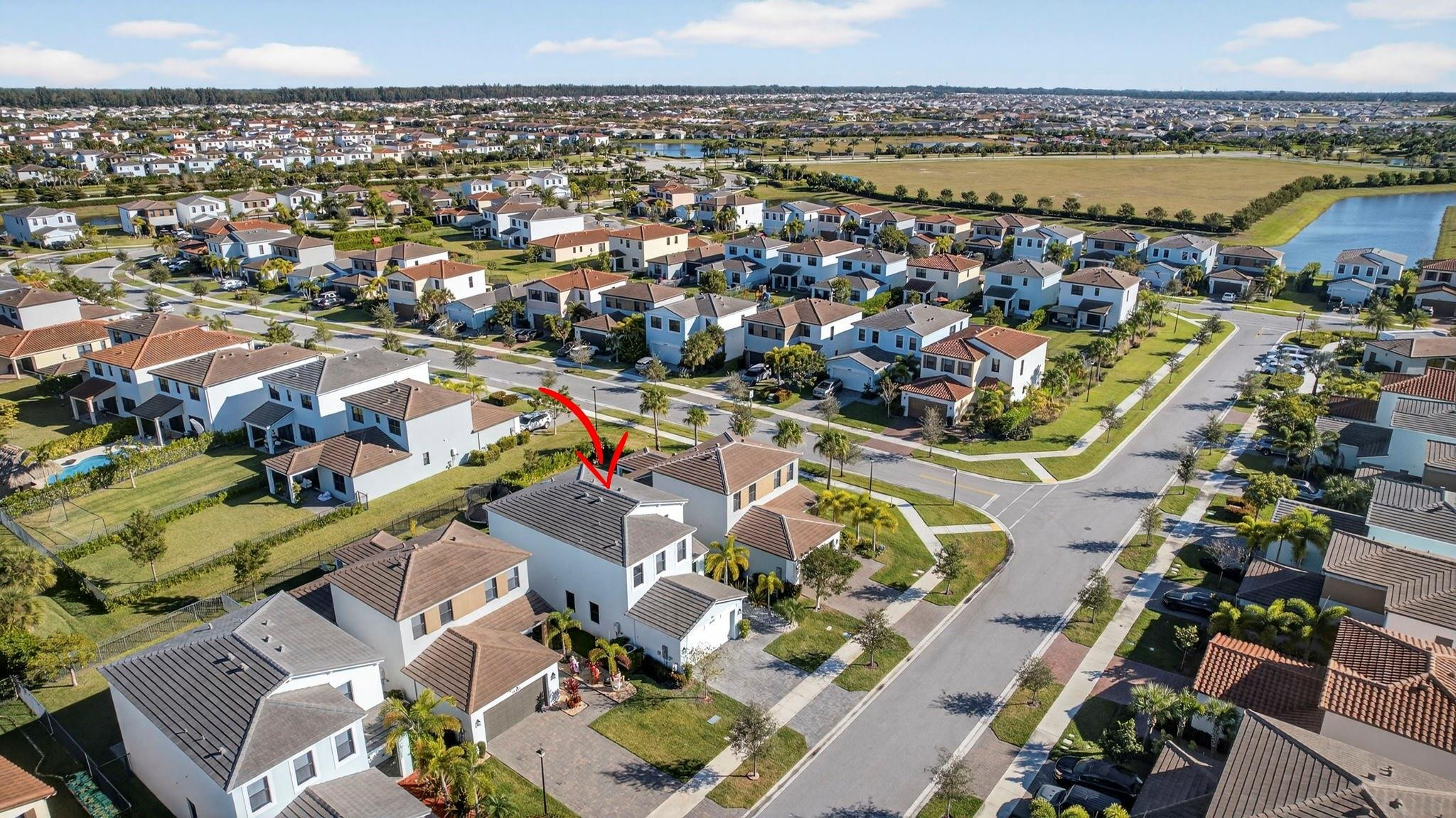 16587 Cove Road The Acreage, FL 33470 - Photo 61 of 69 an aerial view of residential houses with outdoor space