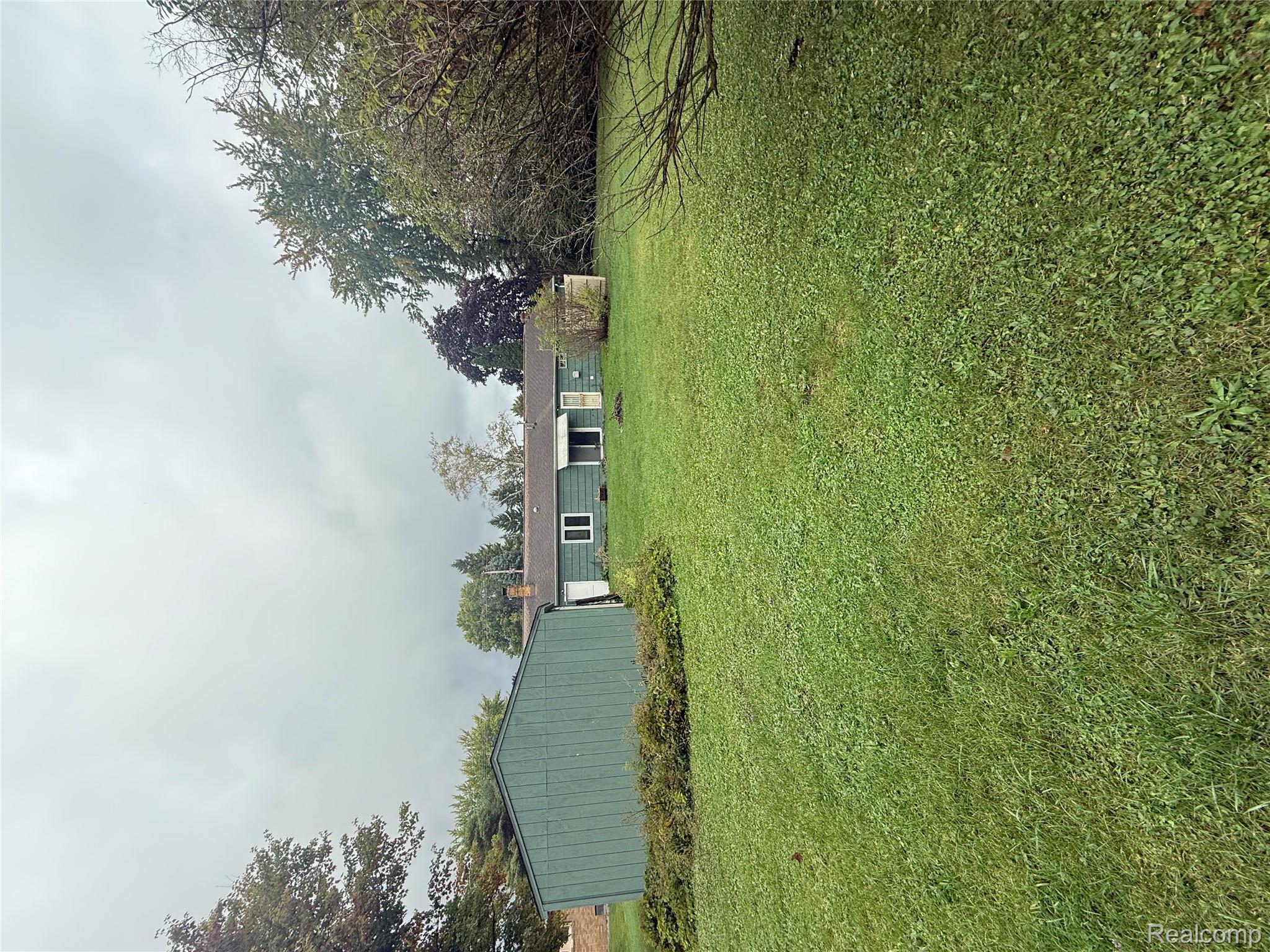 3176 East Fisher Road Bay City, MI 48706 - Photo 23 of 25 Back of property featuring a yard
