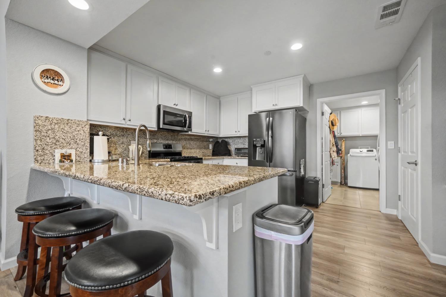 143 Emerald Lane Jackson, CA 95642 - Photo 15 of 53 a kitchen with stainless steel appliances granite countertop a sink a stove a refrigerator a washer and dryer