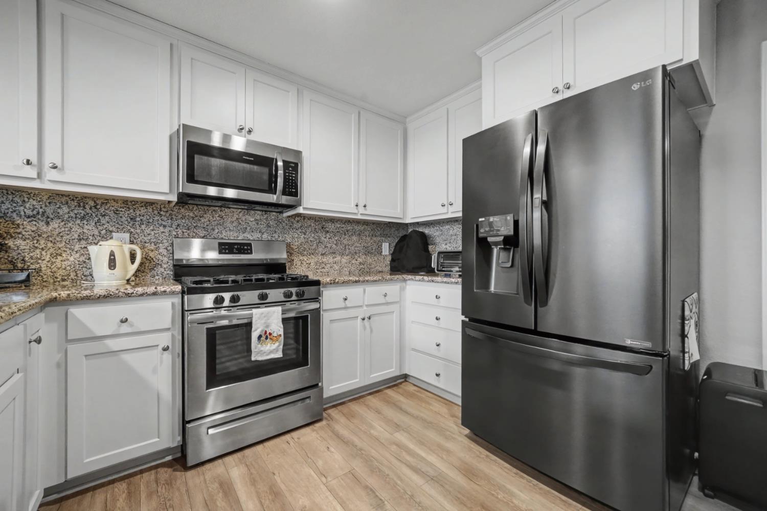 143 Emerald Lane Jackson, CA 95642 - Photo 18 of 53 a kitchen with stainless steel appliances a refrigerator stove and microwave