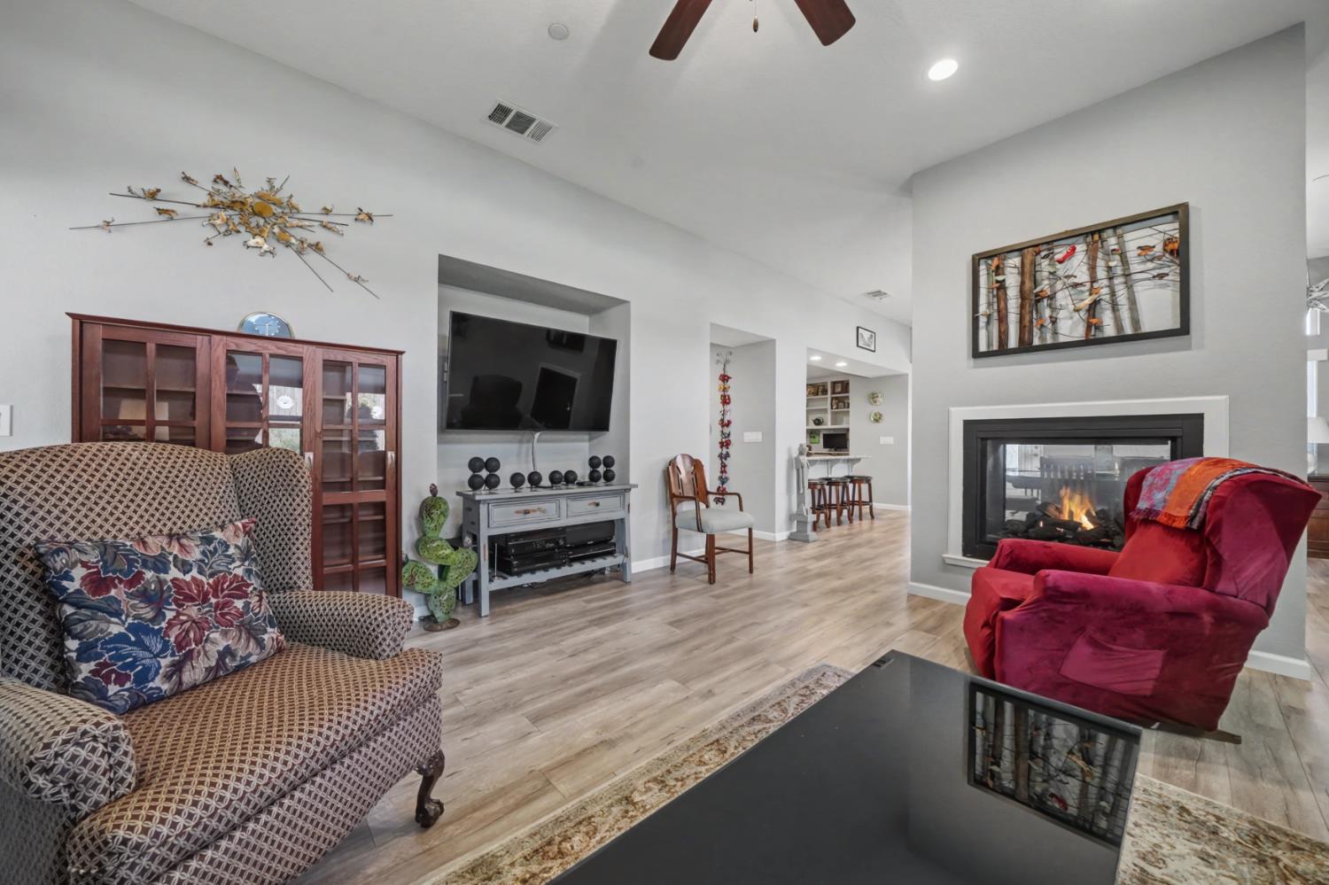 143 Emerald Lane Jackson, CA 95642 - Photo 24 of 53 a living room with furniture a flat screen tv and a fireplace