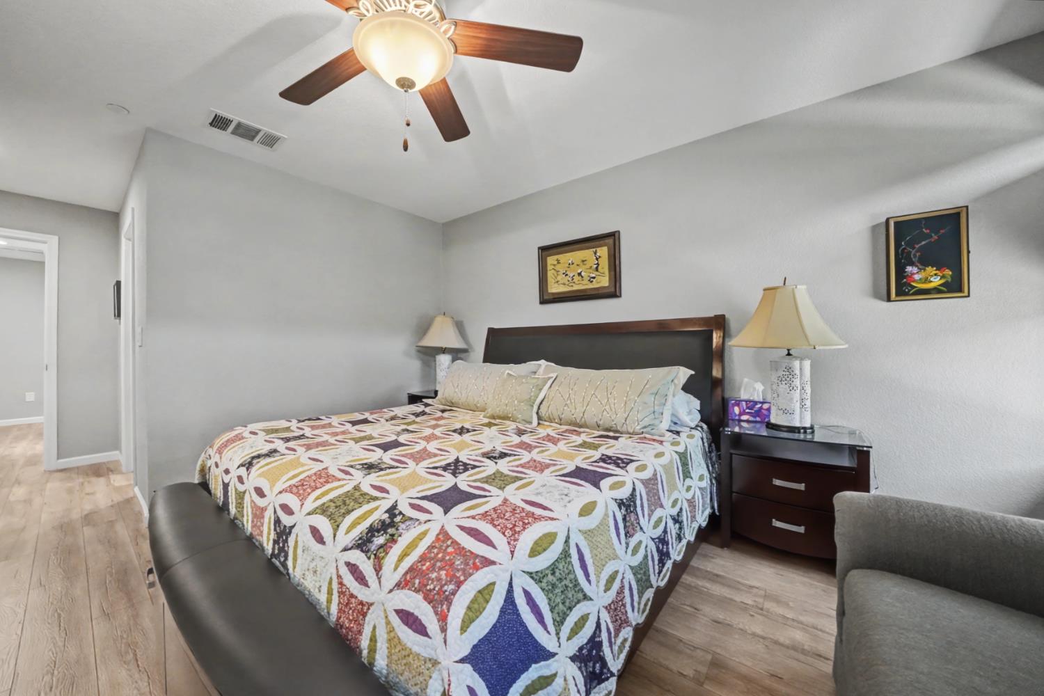 143 Emerald Lane Jackson, CA 95642 - Photo 32 of 53 a bedroom with a bed and a chandelier