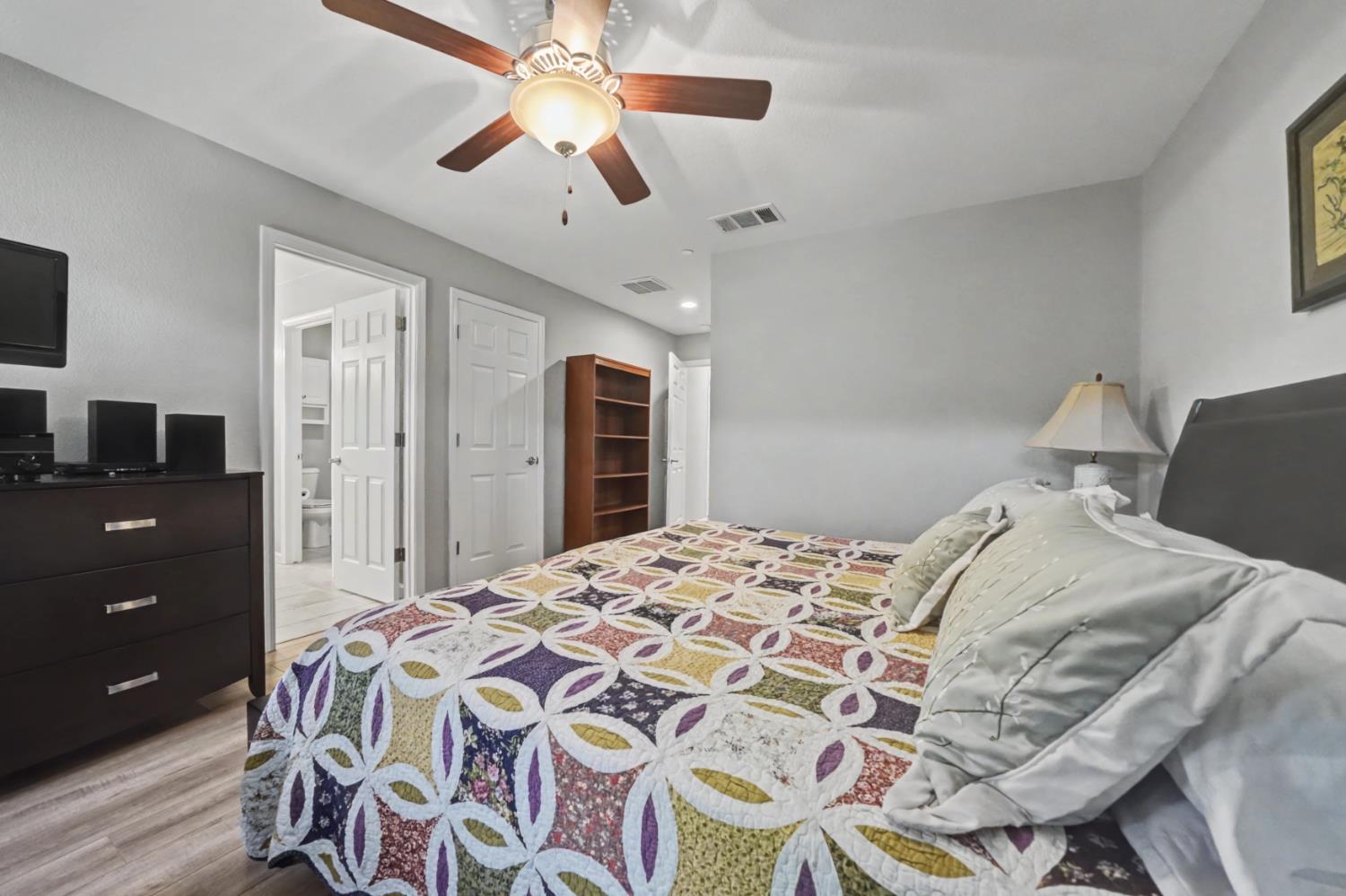 143 Emerald Lane Jackson, CA 95642 - Photo 33 of 53 a bedroom with a bed and a chandelier