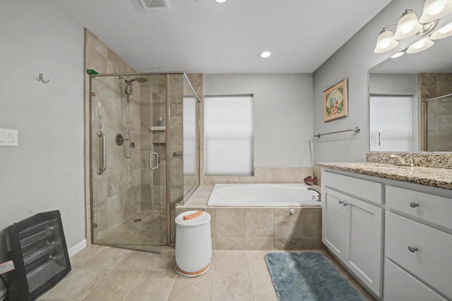 143 Emerald Lane Jackson, CA 95642 - Photo 35 of 53 a spacious bathroom with a double vanity sink toilet mirror and bathtub
