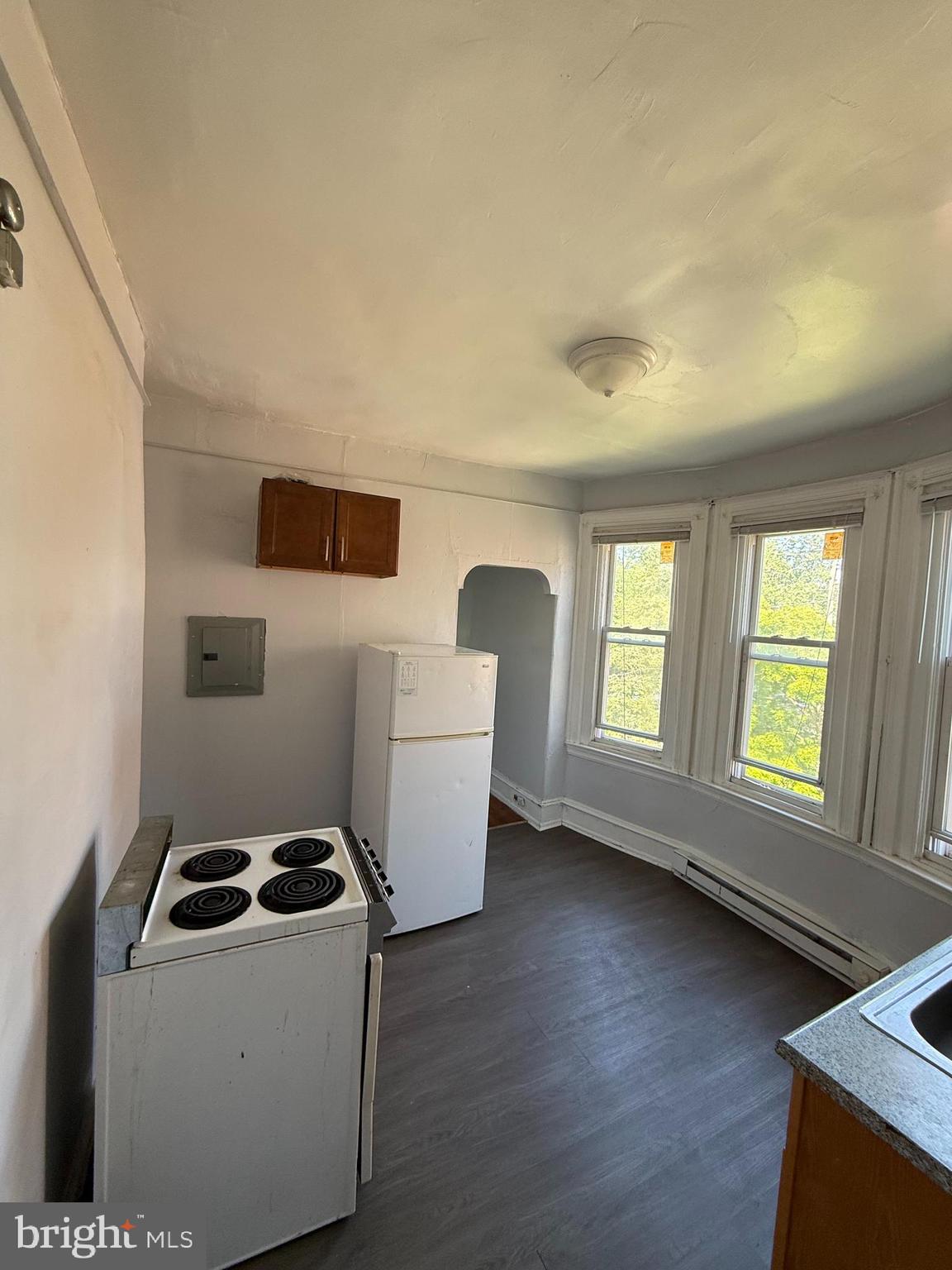 5336 Vine Street, Unit 2F Philadelphia, PA 19139 - Photo 7 of 7 a view of kitchen with furniture wooden floor and windows