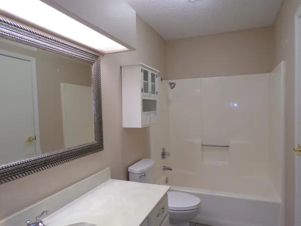 a bathroom with a toilet a sink and bathtub