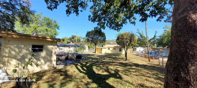 a view of a house with backyard and sitting area