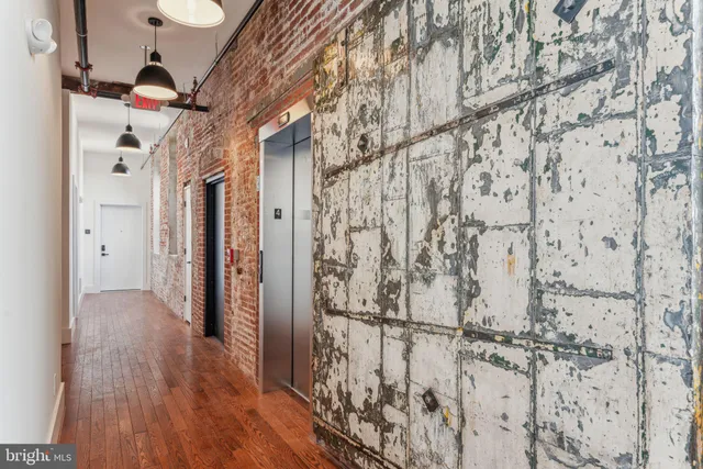 a view of a hallway with wooden floor and entryway
