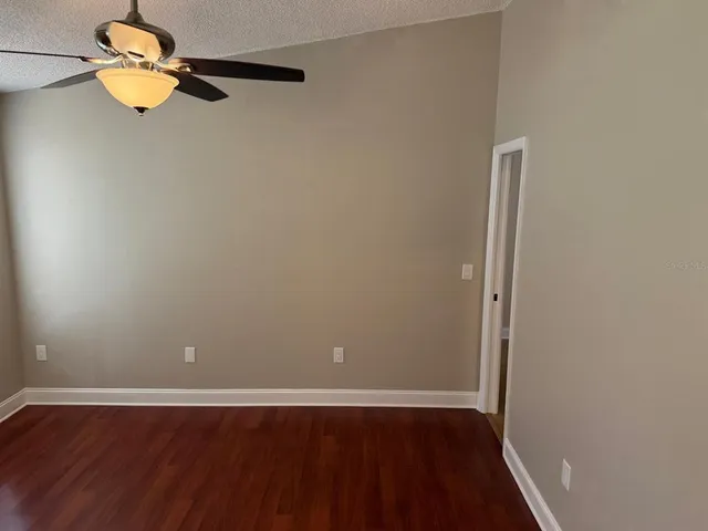 an empty room with wooden floor