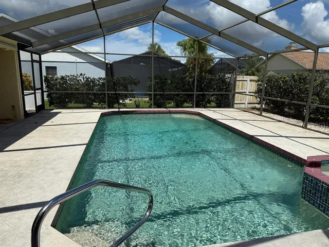a view of a backyard with a tub and wooden fence