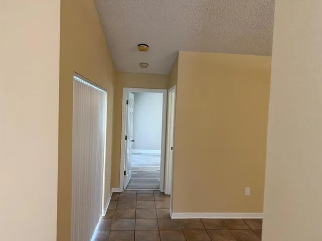 a view of a room with a refrigerator and window