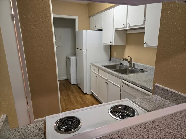 a kitchen with a sink a stove and refrigerator
