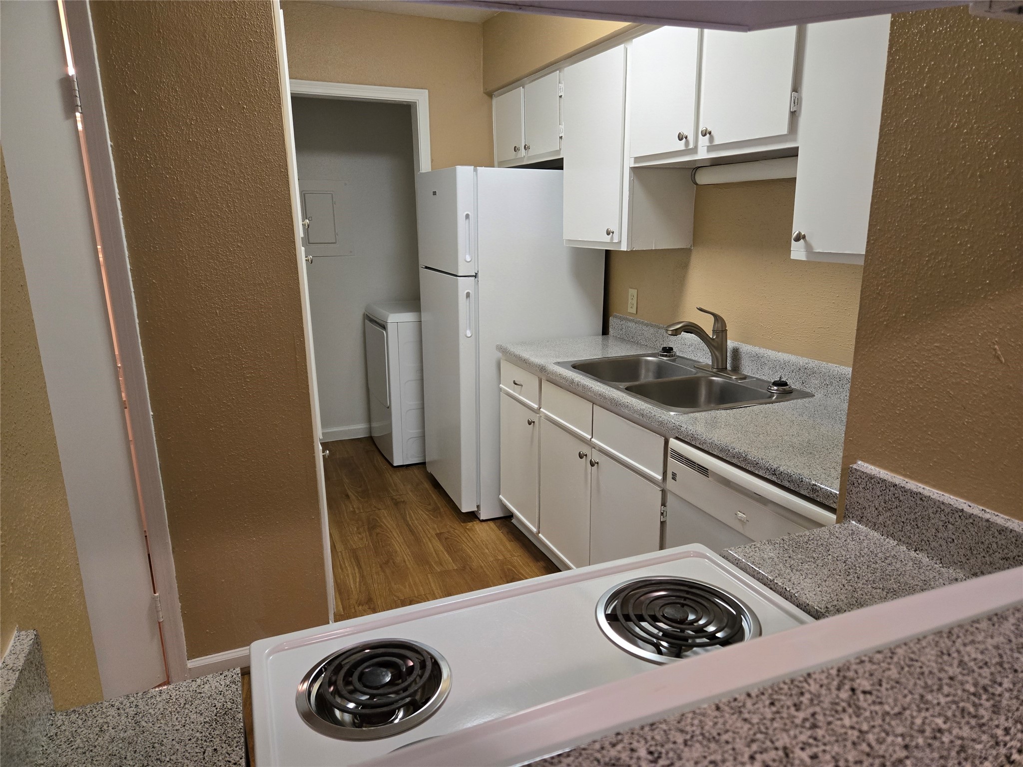 13210 Old Richmond Road, Unit A Houston, TX 77083 - Photo 13 of 21 a kitchen with a sink a stove and refrigerator