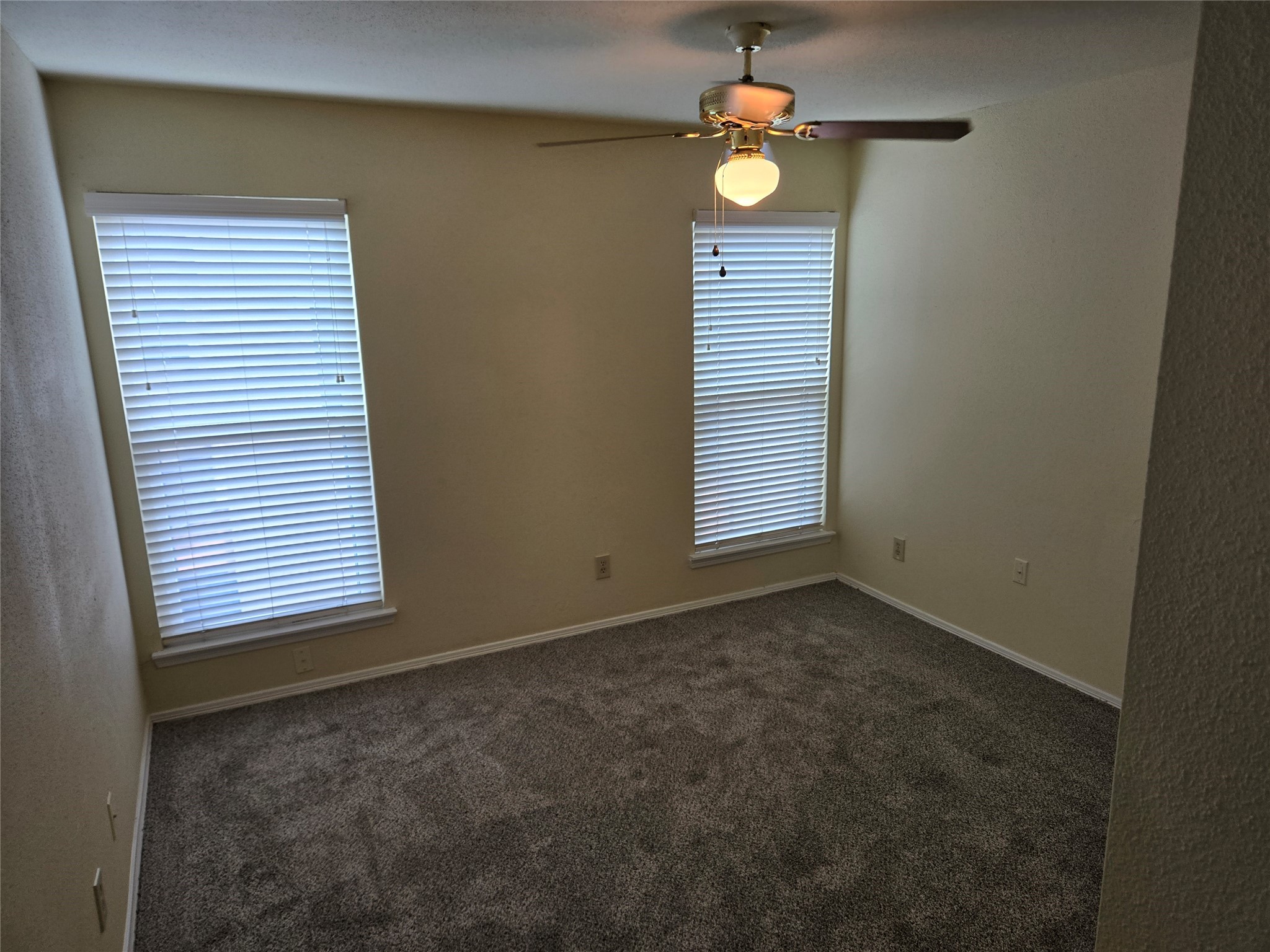 13210 Old Richmond Road, Unit A Houston, TX 77083 - Photo 18 of 21 an empty room with windows and fan