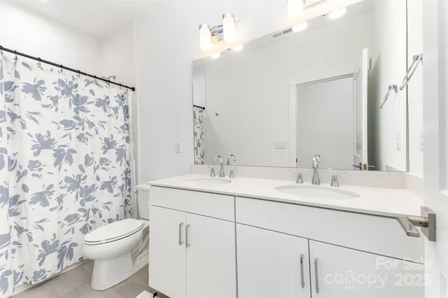 an empty room with windows and furniture