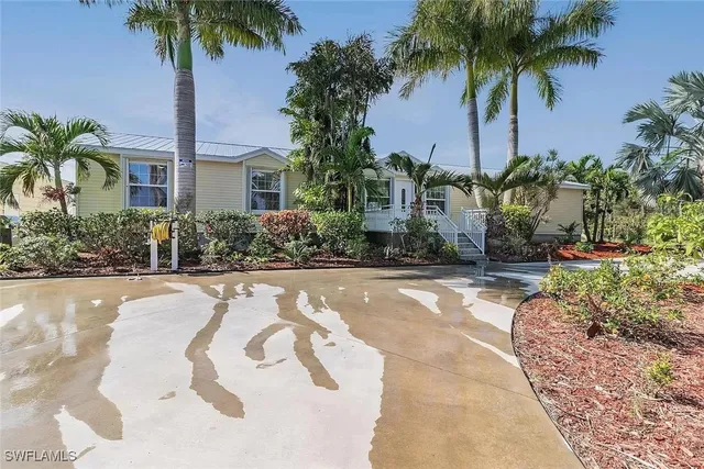 a front view of house with yard and swimming pool