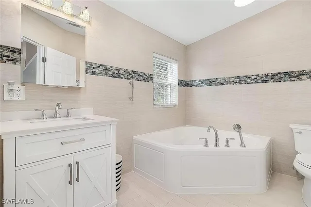 a kitchen with stainless steel appliances granite countertop a stove sink microwave and refrigerator