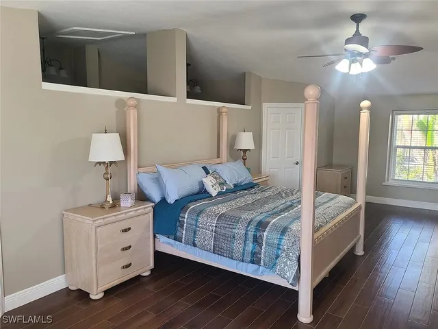 a bed room with a bed and a night stand