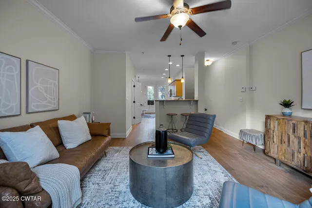 a living room with furniture and a wooden floor