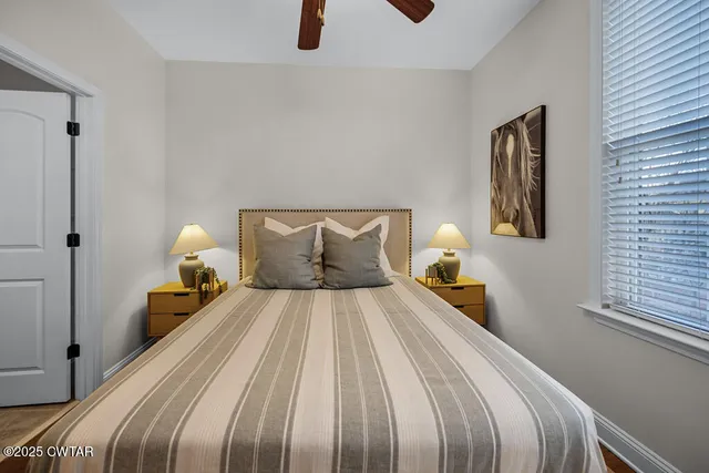 a bedroom with a bed and a lamp