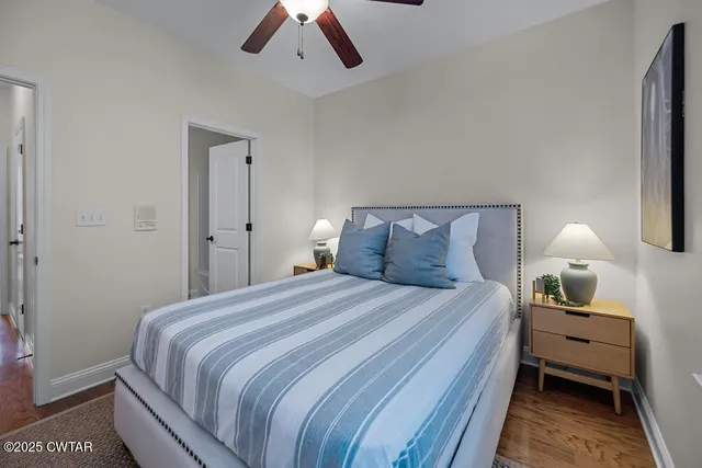 a bedroom with a bed and a lamp