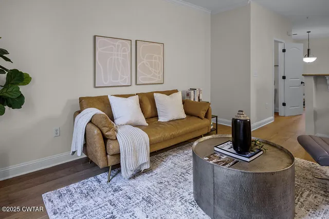 a living room with furniture and wooden floor