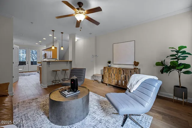 a living room with furniture and a chandelier