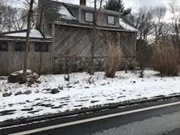 a view of white house covered with snow