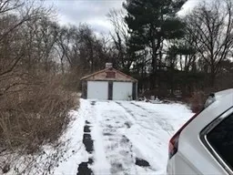 a wooden bench sitting in front of a house