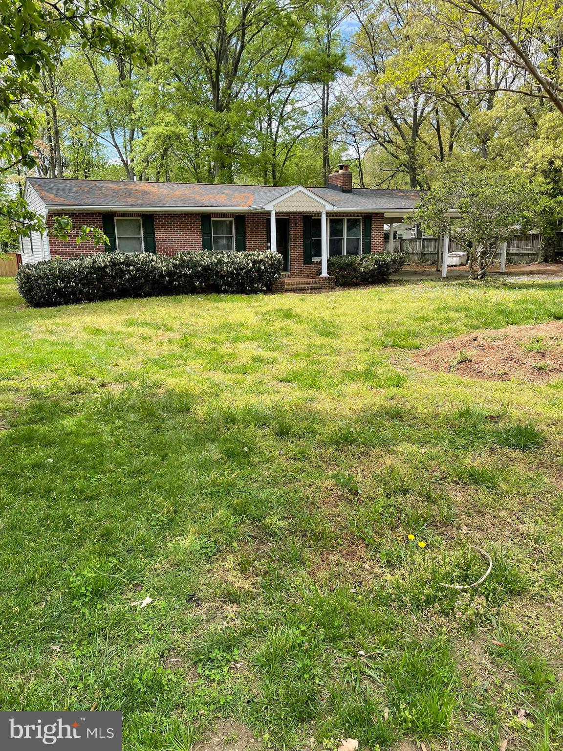 a front view of a house with yard and trees