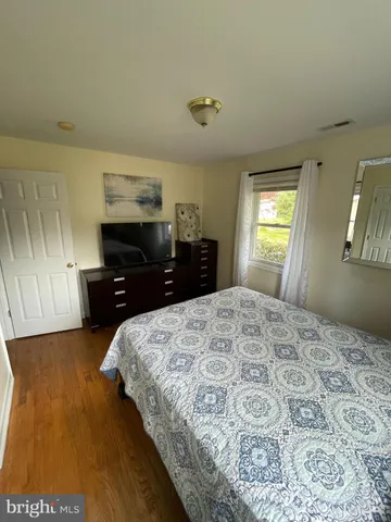 a bedroom with a bed and a dresser