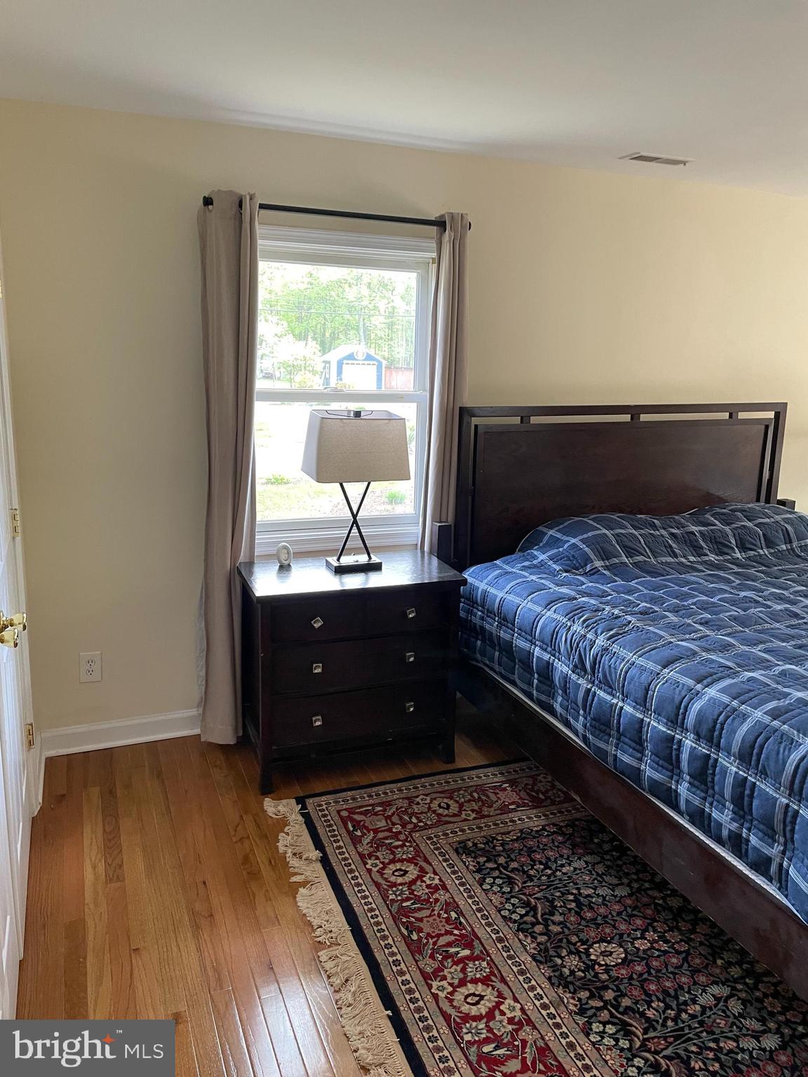 3460 Cohasset Avenue Annapolis, MD 21403 - Photo 17 of 29 a bedroom with a bed and wooden floor