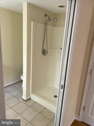 a bathroom with a glass shower door