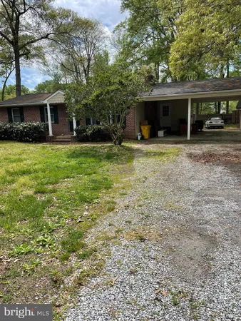 a front view of a house with a yard and a garage