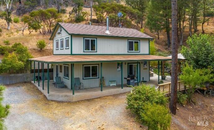 a view of a house with backyard porch and sitting area