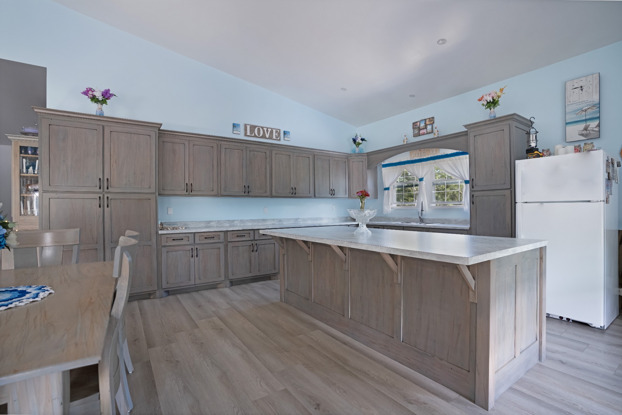 1779 Mt Zion Road Big Sandy, TN 38221 - Photo 12 of 31 a kitchen with a sink a refrigerator and wooden floor