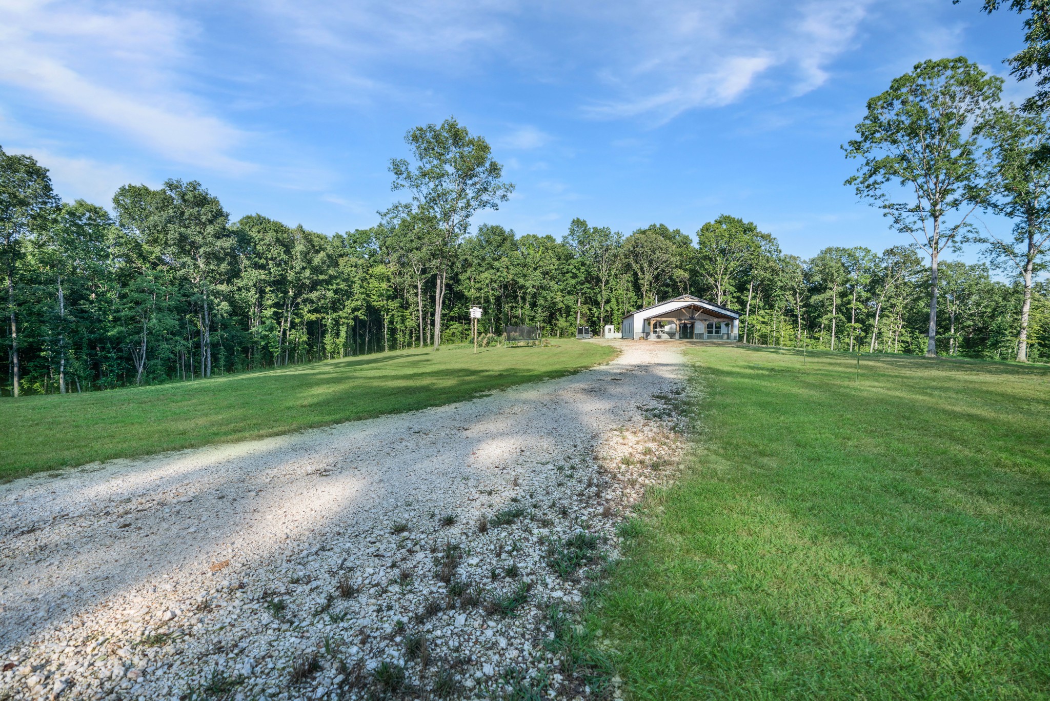 1779 Mt Zion Road Big Sandy, TN 38221 - Photo 5 of 31 a view of a park with large trees and a houses