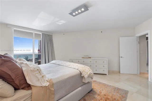 a bedroom with a large bed and a large window