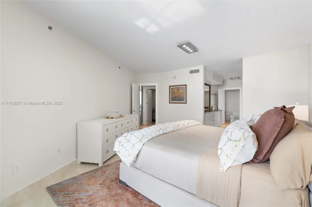 a bedroom with a bed and a lamp