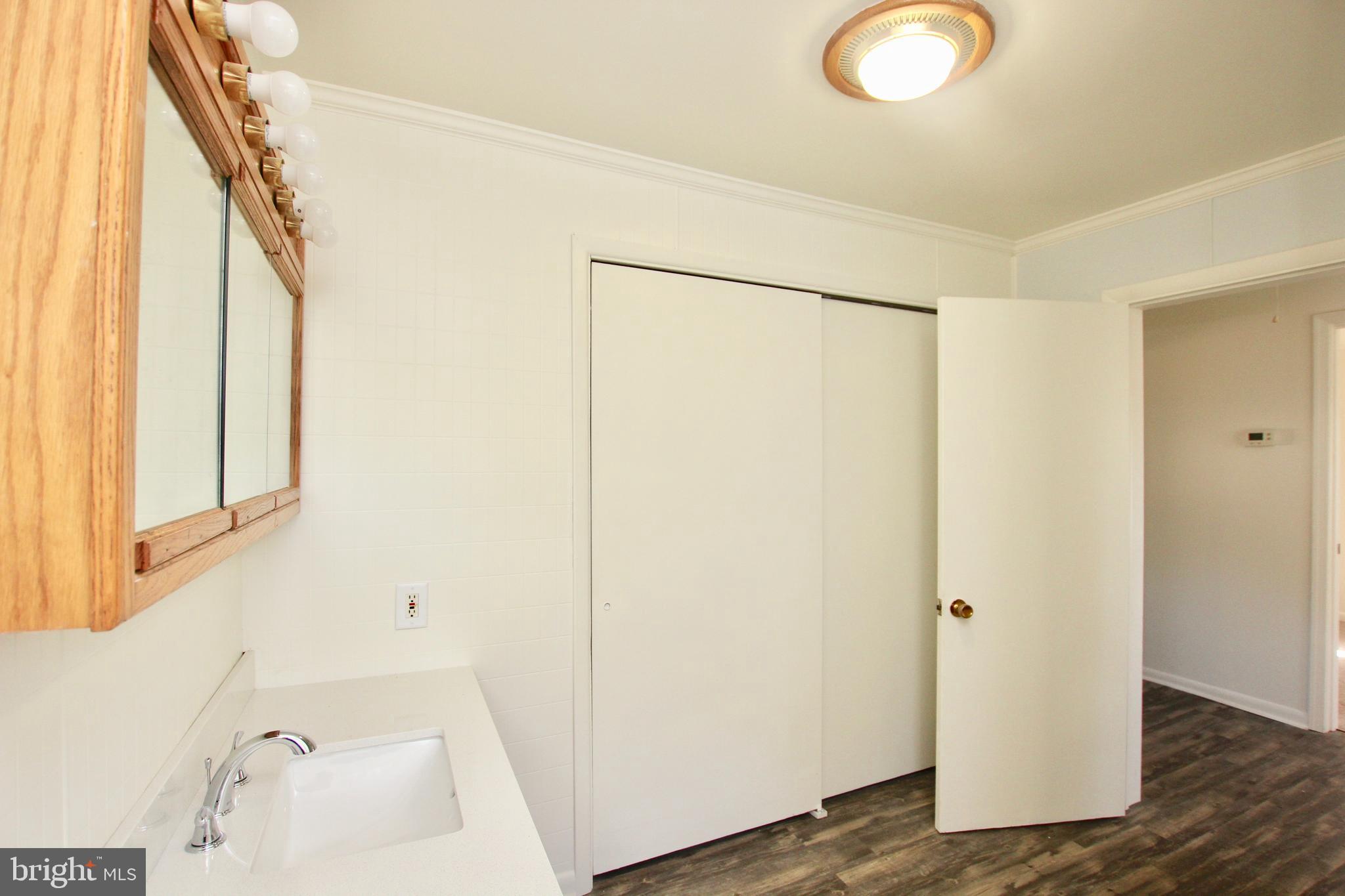 5807 Eldorado Sharptown Road Rhodesdale, MD 21659 - Photo 15 of 24 Bathroom with laundry closet
