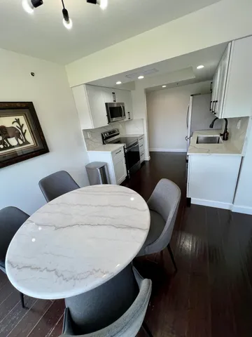 a large kitchen with a table and chairs