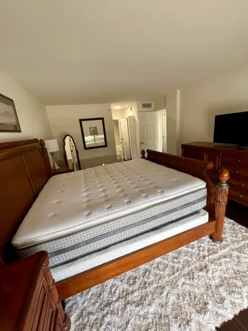 a bedroom with a bed and window