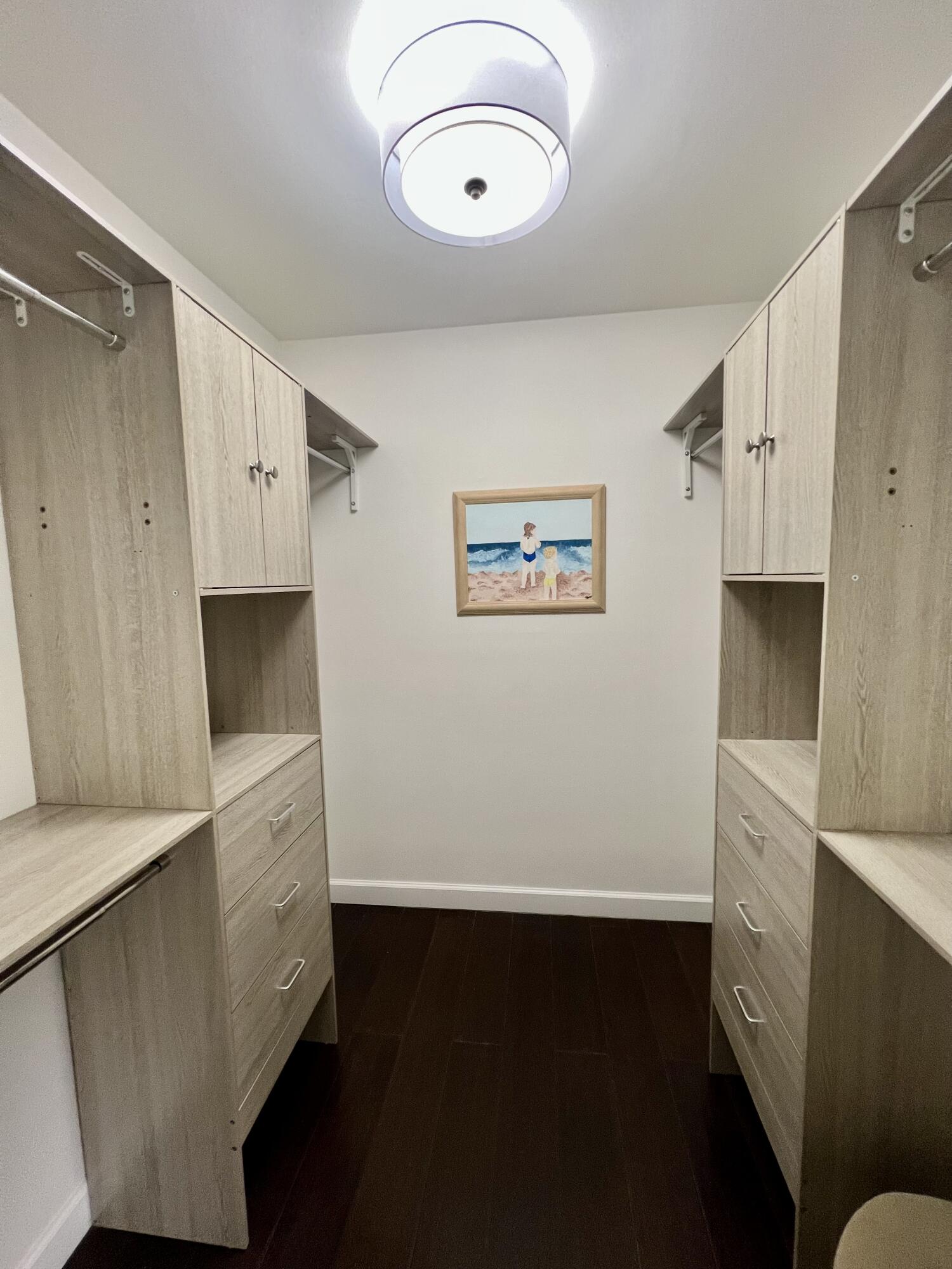 23200 Camino Del Mar, Unit 303 Boca Raton, FL 33433 - Photo 14 of 33 a view of cabinets with wooden floor