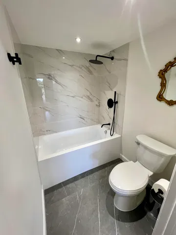 a bathroom with a toilet a sink and bathtub