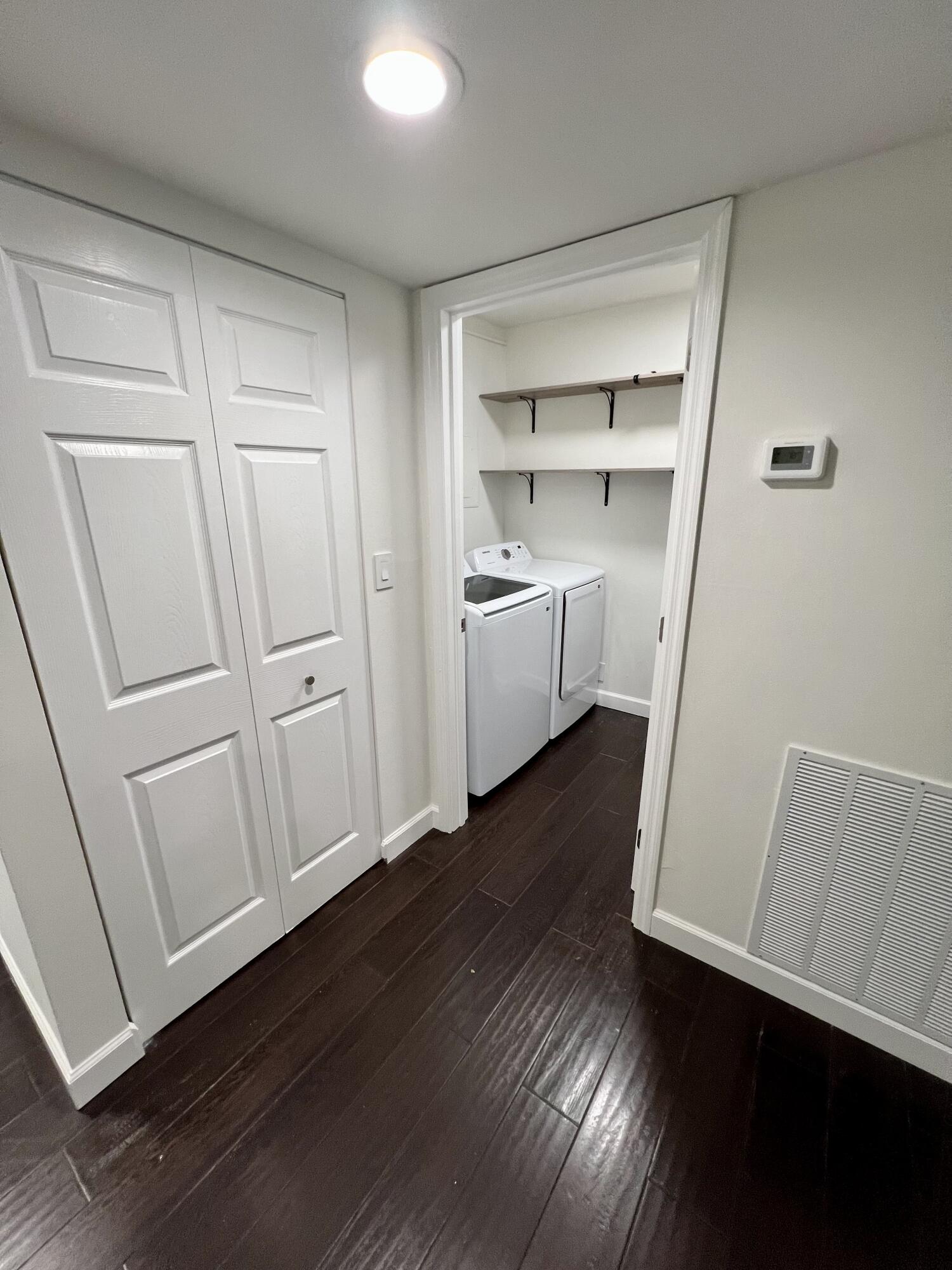 23200 Camino Del Mar, Unit 303 Boca Raton, FL 33433 - Photo 23 of 33 a room with white cabinets and wooden floor
