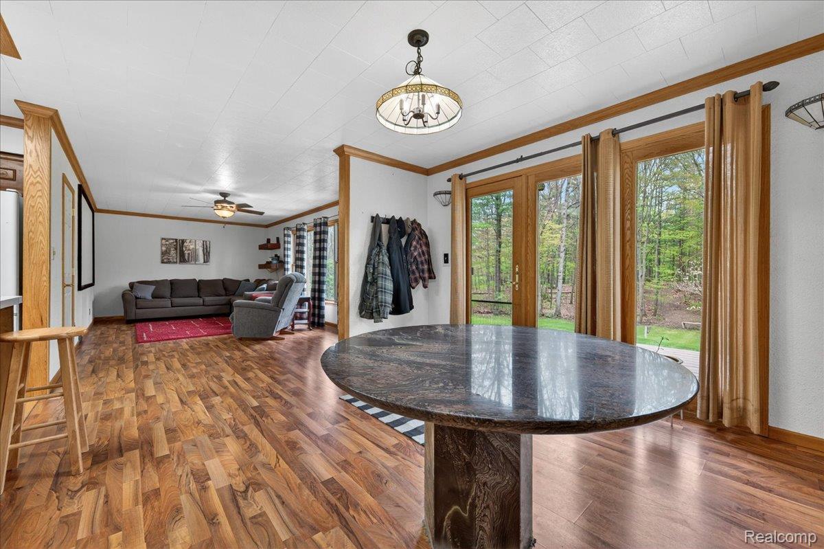 4049 Slattery Road North Branch, MI 48461 - Photo 17 of 45 Dining space with wood finished floors, ornamental molding, ceiling fan, and french doors