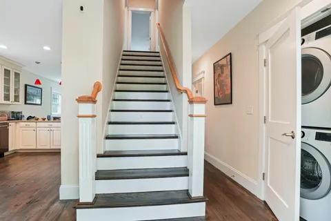a view of entryway with wooden floor and washer dryer