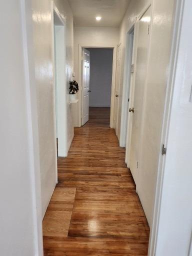 2011 11th Street Reedley, CA 93654 - Photo 12 of 17 a view of a hallway with wooden floor and staircase