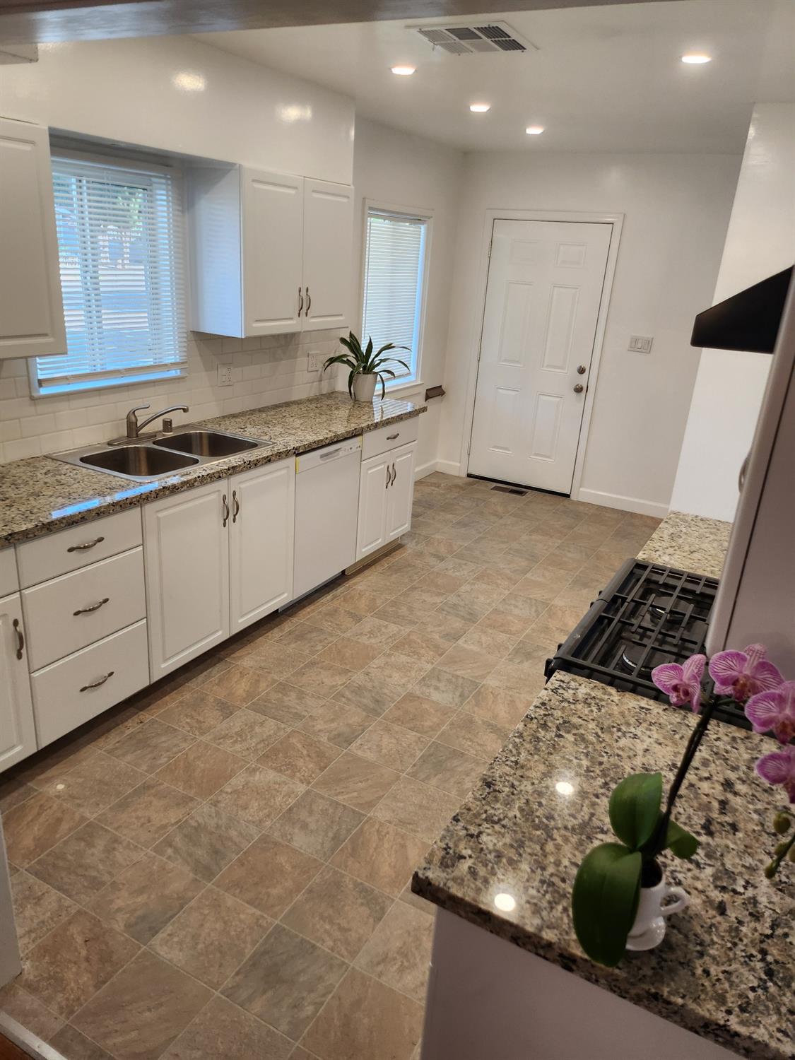 2011 11th Street Reedley, CA 93654 - Photo 5 of 17 a kitchen with stainless steel appliances granite countertop a sink and a stove